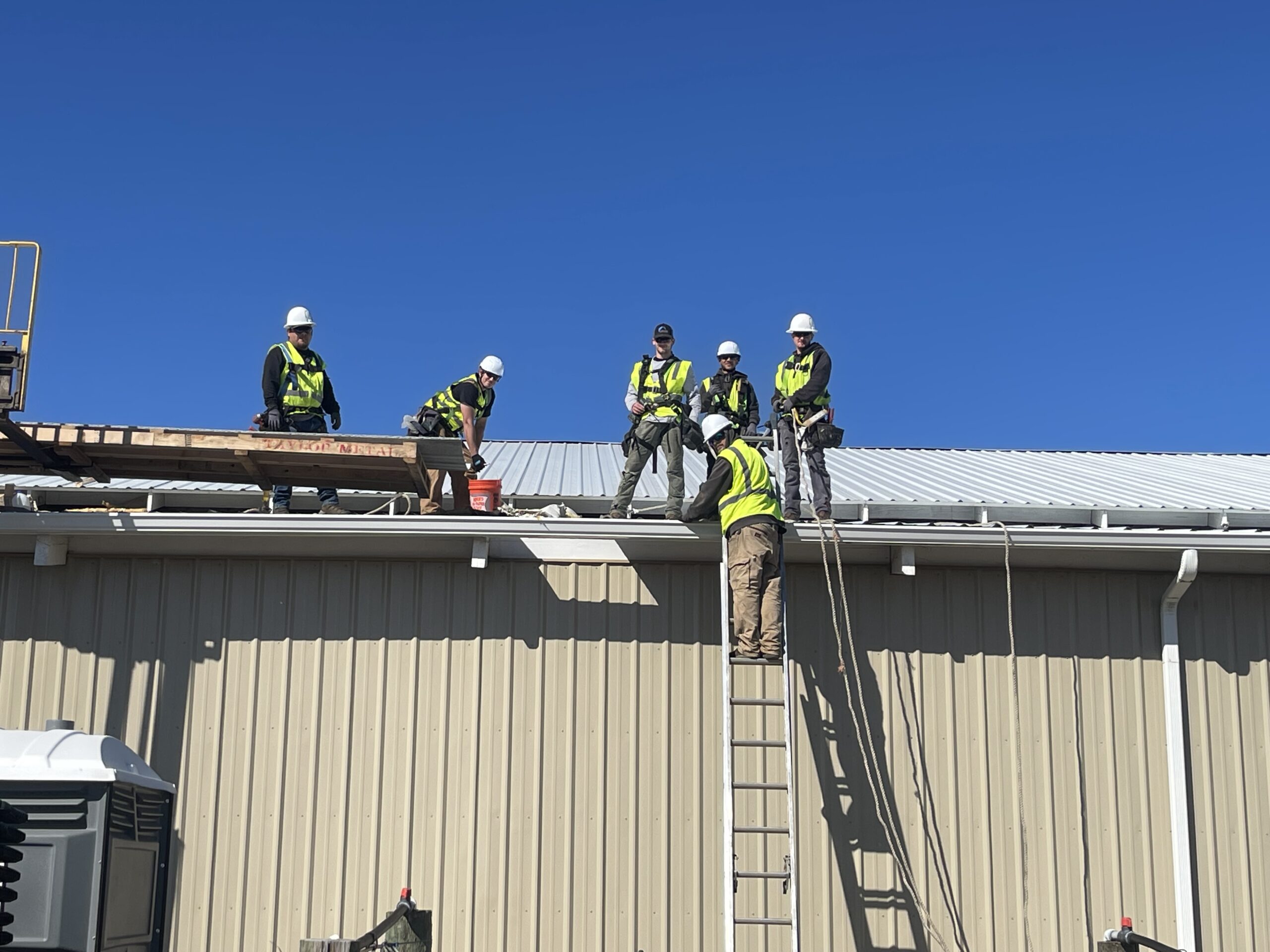 Crew Installing metal roof